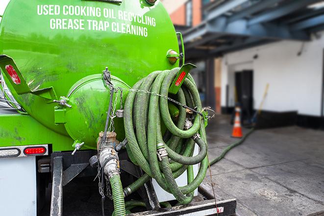 large truck pumping grease trap at a restaurant in Cascade